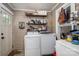 Functional laundry room featuring a washer, dryer, shelving and natural light from the window at 211 Hershel Lackey Rd, Lincolnton, NC 28092
