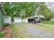 View of outbuildings, garage and storage, plus gravel driveway in rear at 211 Hershel Lackey Rd, Lincolnton, NC 28092