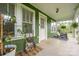 Inviting front porch with decorative plants, seating, and a pleasant, shaded ambiance at 211 Hershel Lackey Rd, Lincolnton, NC 28092