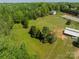 Aerial view features a large grassy lot, bordered by trees and a fenced in home at 228 Red Dog Dr, Mooresville, NC 28115