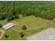 Aerial view of the property featuring horse stables, paddock, and expansive green pasture at 228 Red Dog Dr, Mooresville, NC 28115