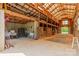 Barn interior features a tall ceiling with wooden beams, and multiple wooden horse stalls at 228 Red Dog Dr, Mooresville, NC 28115