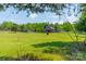 Exterior of a gray barn featuring a spacious green field and partial tree line at 228 Red Dog Dr, Mooresville, NC 28115