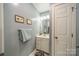 Bathroom with white vanity, a round mirror and gray walls at 228 Red Dog Dr, Mooresville, NC 28115