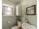 Small bathroom with painted wood paneled walls features a pedestal sink at 228 Red Dog Dr, Mooresville, NC 28115