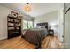 Bedroom featuring a comfortable bed, side table, and bookshelf near a window at 228 Red Dog Dr, Mooresville, NC 28115