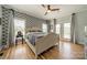 Comfortable bedroom with hardwood floors, patterned wallpaper, a ceiling fan, and bright natural light at 228 Red Dog Dr, Mooresville, NC 28115