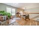 Bright bonus room featuring hardwood floors, piano, guitar, and a yoga mat at 228 Red Dog Dr, Mooresville, NC 28115