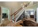 Open foyer showcasing hardwood floors, a staircase, and views into adjacent living spaces at 228 Red Dog Dr, Mooresville, NC 28115