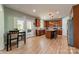 Spacious eat-in kitchen with hardwood floors, stainless steel appliances, and a kitchen island with bar stool seating at 228 Red Dog Dr, Mooresville, NC 28115