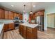 Charming kitchen with stainless steel appliances, wooden cabinetry, a kitchen island, and hardwood floors at 228 Red Dog Dr, Mooresville, NC 28115