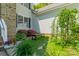 Charming garden nook with flowers, and decorative plants under the window at 228 Red Dog Dr, Mooresville, NC 28115