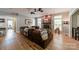 Cozy living room with a stone fireplace, hardwood floors, and a large leather couch with throw blankets at 228 Red Dog Dr, Mooresville, NC 28115