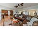 Comfortable living room area featuring hardwood floors, a large leather couch and easy access to the kitchen at 228 Red Dog Dr, Mooresville, NC 28115