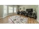 Bright office with hardwood floors, two desks, and large windows offering lots of natural light at 228 Red Dog Dr, Mooresville, NC 28115