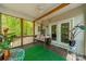 Charming outdoor porch area with wooden floors, a porch swing, and lots of leafy green plants at 228 Red Dog Dr, Mooresville, NC 28115