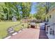 Backyard with a deck, stepping stone path, grilling area and storage shed at 2614 Thornton Rd, Charlotte, NC 28208