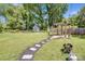 A backyard featuring a grilling area, gazebo, and stepping stone path at 2614 Thornton Rd, Charlotte, NC 28208