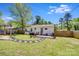 Spacious backyard features a grilling area, deck, stepping stone path, and fenced yard at 2614 Thornton Rd, Charlotte, NC 28208
