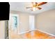 Bedroom with hardwood floors, neutral paint, and white trim leading to another room at 2614 Thornton Rd, Charlotte, NC 28208