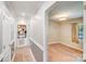 Hallway view to bedroom with neutral paint, hardwood floor, and overhead lighting at 2614 Thornton Rd, Charlotte, NC 28208