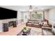 Living room boasting a fireplace, large TV, wood floors, and modern leather furniture at 2614 Thornton Rd, Charlotte, NC 28208