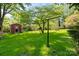 The backyard includes a red shed with a lush green lawn, and a bird feeder in a private, shaded area at 2721 Albany Ln, Charlotte, NC 28205