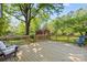 Large wooden deck with seating, perfect for outdoor living and entertaining, with views of the landscaped backyard at 2721 Albany Ln, Charlotte, NC 28205