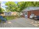Expansive wooden deck with outdoor seating offering views of the grassy backyard and convenient storage shed at 2721 Albany Ln, Charlotte, NC 28205