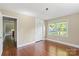 Bright bedroom with hardwood flooring, closet, and natural light streaming through the large window at 2721 Albany Ln, Charlotte, NC 28205