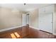 Spacious bedroom featuring hardwood floors, a ceiling light, and built-in wardrobe cabinets at 2721 Albany Ln, Charlotte, NC 28205