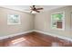 Bedroom features hardwood floors, a ceiling fan and two windows providing natural light at 2721 Albany Ln, Charlotte, NC 28205