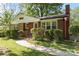 Charming brick home with a well-manicured lawn and walkway leading to the front door at 2721 Albany Ln, Charlotte, NC 28205