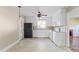 Bright kitchen with tile flooring, white cabinets, and black refrigerator at 2721 Albany Ln, Charlotte, NC 28205
