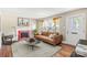 Bright living room featuring hardwood floors, fireplace, and large windows with natural light at 2721 Albany Ln, Charlotte, NC 28205