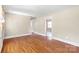 Open living room featuring hardwood floors and neutral walls at 2721 Albany Ln, Charlotte, NC 28205