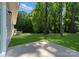 Spacious backyard featuring a concrete patio and lush greenery, perfect for outdoor entertaining at 3021 Dylan Nw Pl, Concord, NC 28027