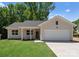 Inviting single-story home showcasing a well-manicured lawn, covered porch, and attached garage at 3021 Dylan Nw Pl, Concord, NC 28027