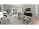 Bright living room featuring large windows and sliding glass doors, modern furnishings, and neutral color palette at 3021 Dylan Nw Pl, Concord, NC 28027