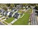 Aerial view of gray two-story homes with a white fence, shed, and a lush grass lawn at 3804 Freedom Dr, Charlotte, NC 28208