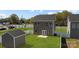 Backyard of a gray two-story home with a white fence, shed, and a grass lawn at 3804 Freedom Dr, Charlotte, NC 28208