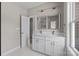 Modern bathroom featuring double sinks, marble flooring, and bright natural light from the large window at 3804 Freedom Dr, Charlotte, NC 28208