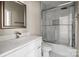 Bathroom featuring a glass shower, white marble walls, and modern fixtures at 3804 Freedom Dr, Charlotte, NC 28208