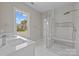 Bright bathroom featuring a glass shower, white marble walls, a modern vanity, and new fixtures at 3804 Freedom Dr, Charlotte, NC 28208