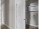 Hallway with access to laundry and storage area featuring neutral walls and light wood-look flooring at 3804 Freedom Dr, Charlotte, NC 28208
