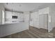 Modern kitchen features white cabinetry, stainless steel appliances, a breakfast bar and luxury vinyl plank flooring at 3804 Freedom Dr, Charlotte, NC 28208
