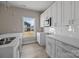 Bright kitchen featuring stainless steel appliances, white cabinetry, a breakfast bar and luxury vinyl plank flooring at 3804 Freedom Dr, Charlotte, NC 28208