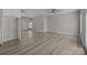 Open-concept living room with light grey walls, ceiling fan and new floors at 3804 Freedom Dr, Charlotte, NC 28208