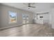 Bright, open living area with luxury vinyl plank flooring that leads to the kitchen and out to the backyard at 3804 Freedom Dr, Charlotte, NC 28208