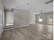 Open-concept living room featuring a stairwell to an upper level and large, new floors at 3804 Freedom Dr, Charlotte, NC 28208